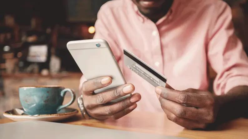men holding card and a mobile