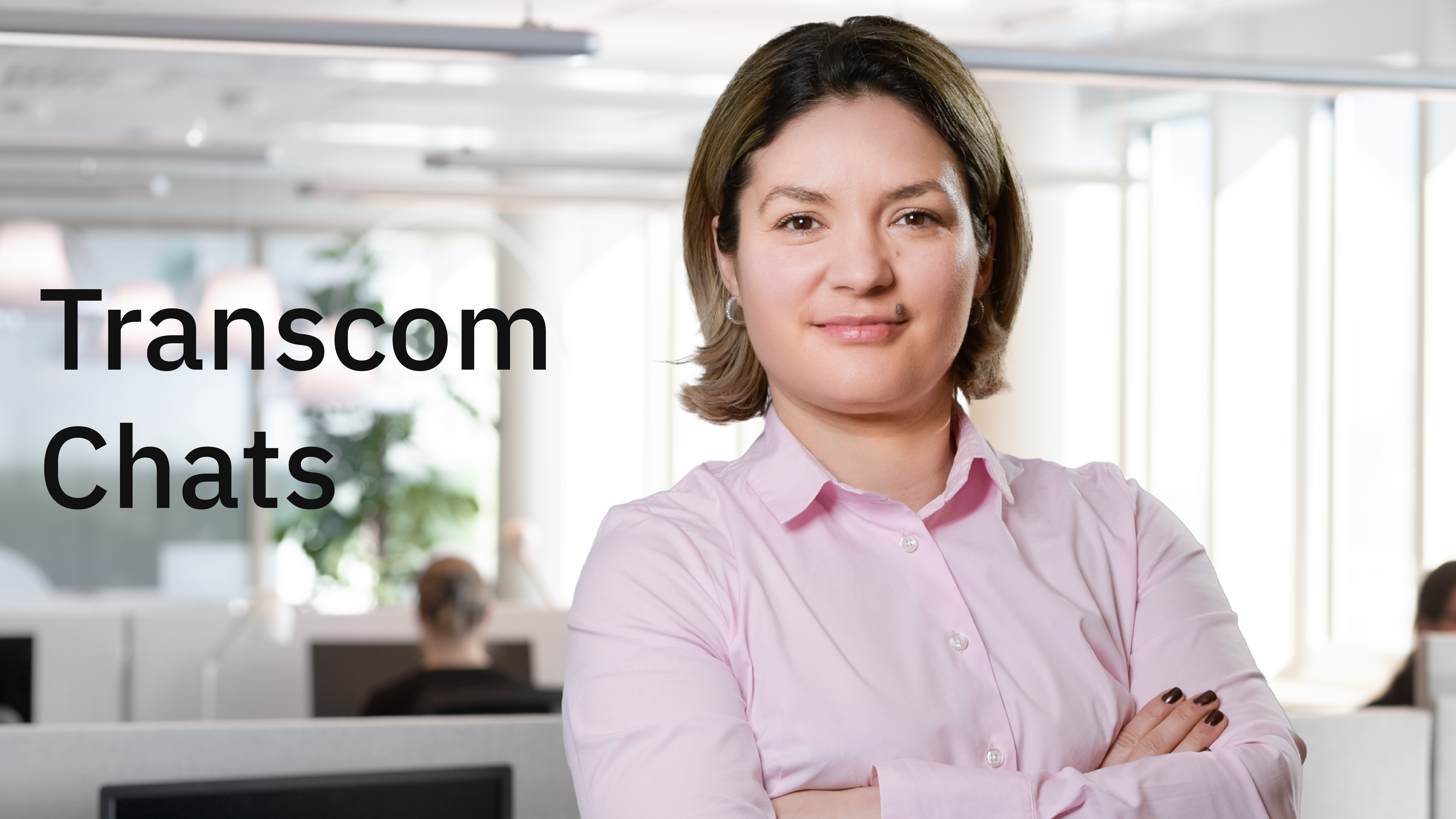 Woman in an office setting looking proud and happy